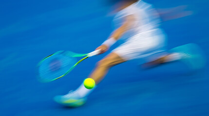 Motion blur of a tennis player hitting a ball during a fast game