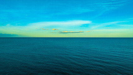 Nature of the beach and sea Summer with sunshine, sandy beaches, clear blue waters sparkling against the sunset sky. On an island with good ecology and environment Background for summer concept