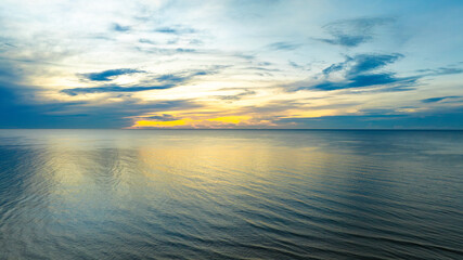 Nature of the beach and sea Summer with sunshine, sandy beaches, clear blue waters sparkling against the sunset sky. On an island with good ecology and environment Background for summer concept