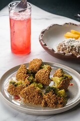 Plate of Fried Broccoli with Red Lemonade