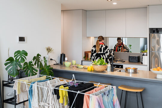 Modern kitchen with laundry drying rack and decor items.
