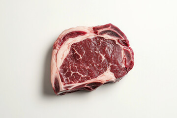Fototapeta premium Piece of beef on white background, seasoned and raw, ready for cooking.