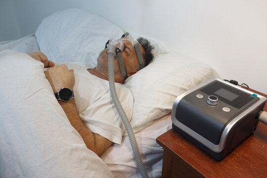 Man Sleeping with CPAP Machine for Sleep Apnea