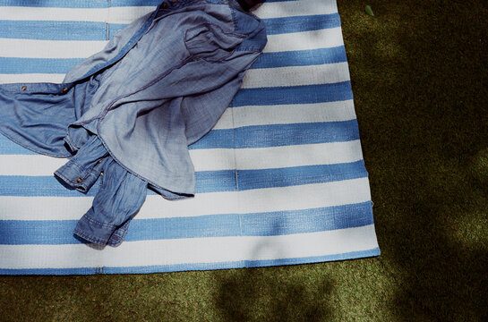 Denim jacket untidy strewing on the blue mat