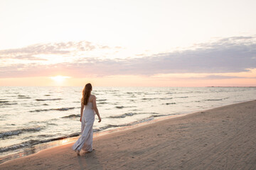 Anonymous woman walking in the beach