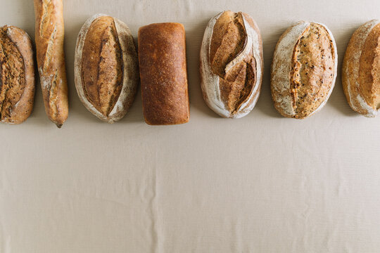 Assortment of various artisanal bread loaves on cloth