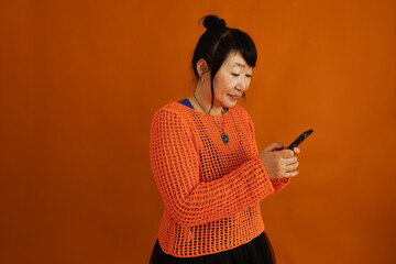 Concentrated mature woman surfing through internet on smartphone