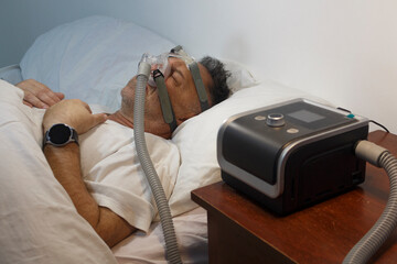Man Sleeping with CPAP Machine for Sleep Apnea