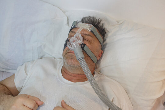 Man Sleeping with CPAP Machine