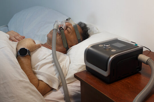 Man Sleeping with CPAP Machine for Sleep Apnea