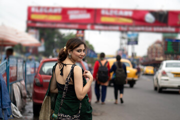 Indian woman walking through busy street in city area