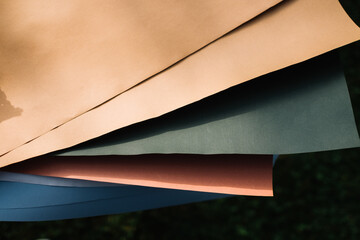 Colored papers in outdoors sunlight, stacked neatly