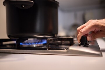 Cooking delicious meals on a modern gas stove using a sleek black pot is an art