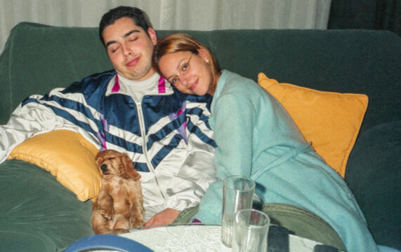 analog film image of young couple at home with their dog