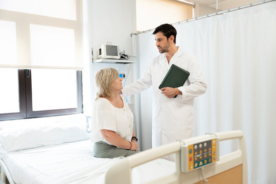 Dotor consulting with patient in hospital box room
