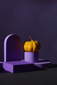 Modern Halloween scene featuring small pumpkins and geometric pu