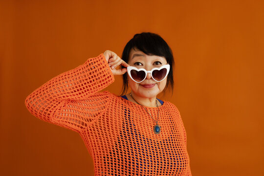 Fashionable female model in sunglasses looking at camera