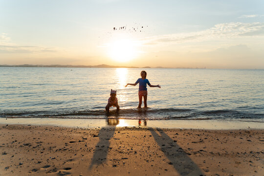 Children Playing at Sunset Beach - Powered by Adobe