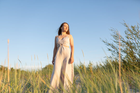 Woman standing between sedges at seaside