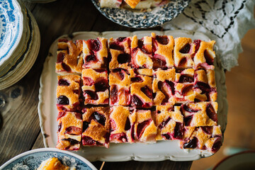 Squares of fruit-topped cake on an ornate platter