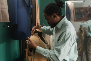 Male Artisan Tailoring Clothes In His Studio