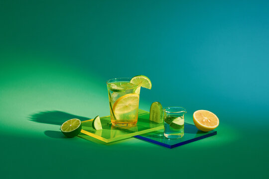 Set of detox water with fruit in glasses isolated on a green bac