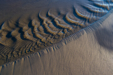 Tide pools and flowing water on beach