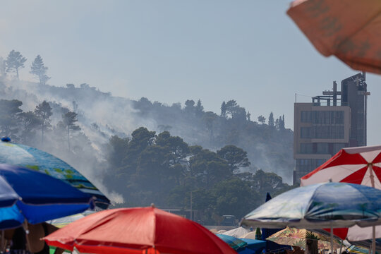 Smoking forest on a hill during the tourist season