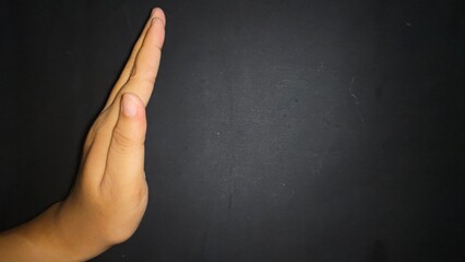 Hand by showing a stop or warning gesture.Isolated on black background