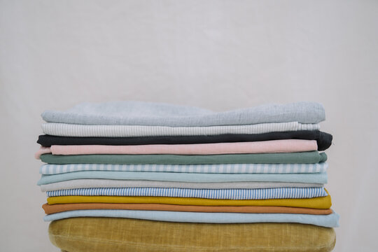 Neatly folded colorful fabrics stacked on a soft surface