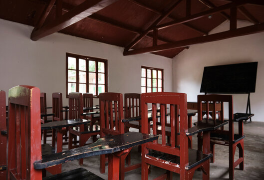 Closeup of old-fashioned desks and chairs in an empty old classroom