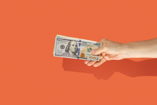 Hand holding US dollars money
