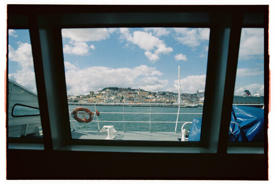 Lisbon view through a window of a ferry 
