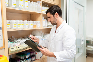 Medical professional reviewing inventory in hospital storage area