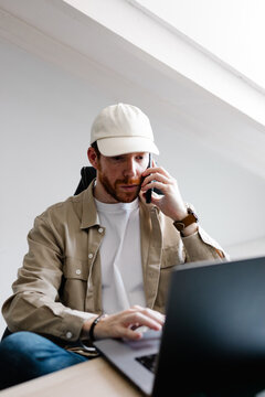 Art director uses a mobile phone to discuss the tasks of a project