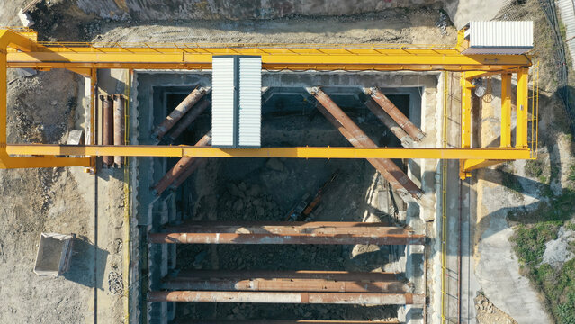 Excavation work at metro station construction surrounded by struts