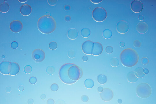 Floating Soap Bubbles Against Blue Sky