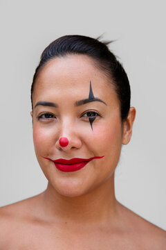 Woman with Clown Makeup Featuring Bold Face Design