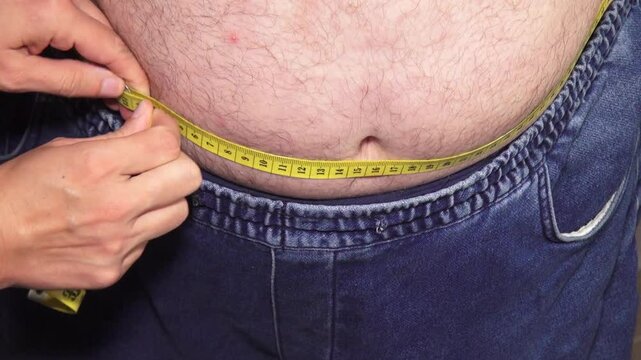 fat overweight man with big belly paunch measure waist circumference