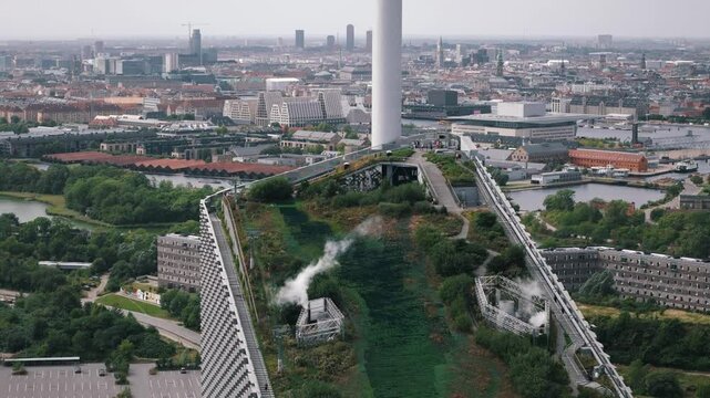 Aerial retreating view of Copenhill ski hill in Copenhagen with people enjoying the rooftop view