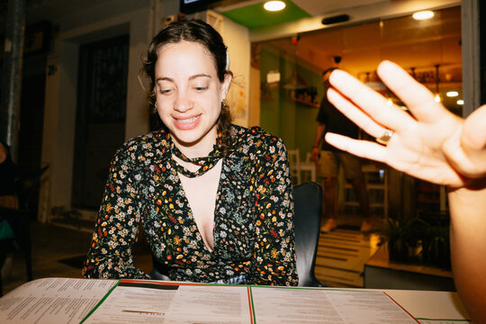 Smiling Woman at Restaurant Table