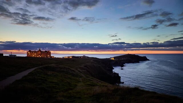 Newquay sunset timelapse showing the historic Headland Hotel and penisula coast. Cornwall, England, UK