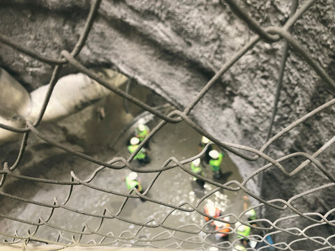 Engineers behind protective wires, view from above