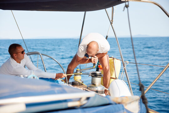 Men sail on the open sea