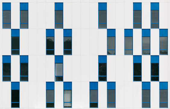 Modern building facade with blue and white geometric windows