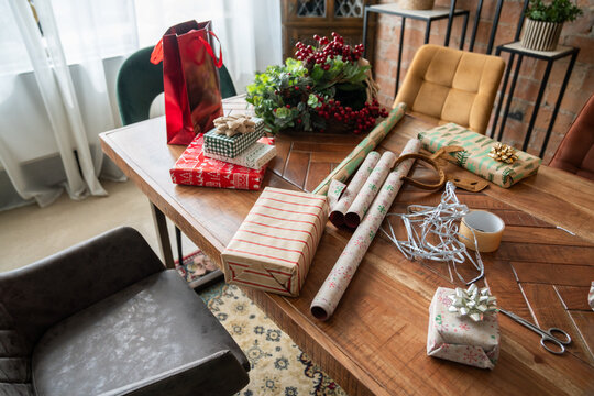 Close up of tabletop with Christmas gifts and wrapping paper