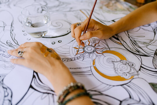 Artist Drawing With Gold Paint