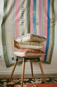 Stacked pillows wooden chair
