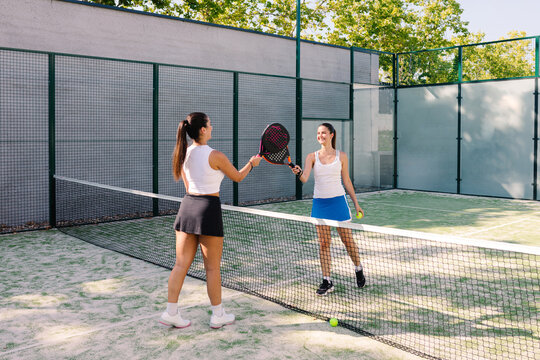 Amateur padel players clash racquets as a sign of sportsmanship