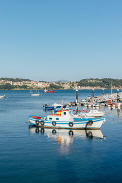Bright painted fishing boats docked in a serene coastal harbor